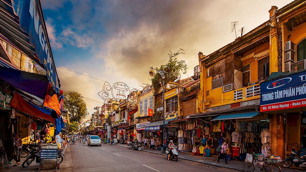 Travelers explore the bustling Old Quarter streets, discovering local crafts and centuries-old architecture that reflect Hanoi’s rich past